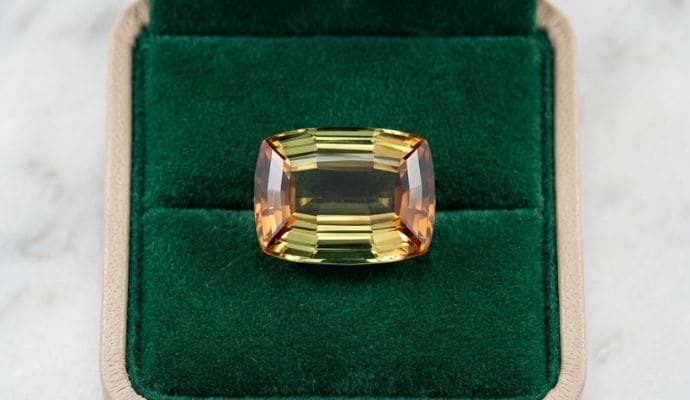 Emerald-cut natural andalusite loose gemstone displayed in a premium velvet box