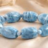 Aquamarine barrel-shaped bead bracelet featuring polished blue gemstone beads