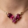 Garnet gold pendant necklace with three-stone design