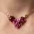 Garnet gold pendant necklace with three-stone design