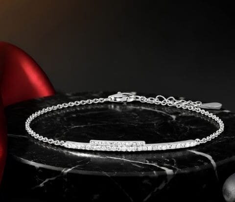 Dainty natural diamond bar bracelet in white gold on black marble display
