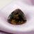 Natural trillion-cut earthfire andalusite loose gemstone on elegant satin fabric