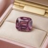 Natural cushion-cut garnet loose gemstone showcased in a luxury jewelry gift box