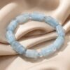 Faceted aquamarine barrel bead bracelet featuring polished natural blue gemstones