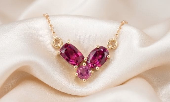 Pink tourmaline gold pendant necklace with three pear-cut gemstones