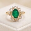 Natural emerald ring in 14K yellow gold with sparkling diamond halo