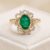 Natural emerald ring in 14K yellow gold with sparkling diamond halo