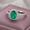 Natural emerald halo ring in white gold with sparkling diamond accents