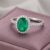 Natural emerald halo ring in white gold with sparkling diamond accents