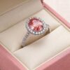 Natural pink sapphire halo ring in white gold with brilliant diamond accents