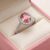 Natural pink sapphire halo ring in white gold with brilliant diamond accents