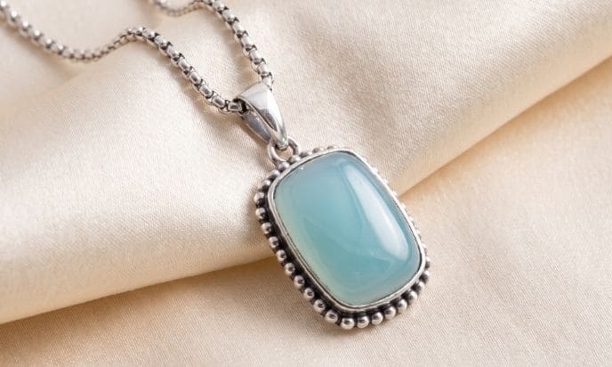 Paraiba agate silver pendant necklace on satin fabric