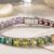 Rainbow gemstone tennis bracelet featuring multicolor square-cut gemstones in white gold