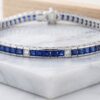 White gold sapphire and diamond tennis bracelet with alternating princess-cut gemstones