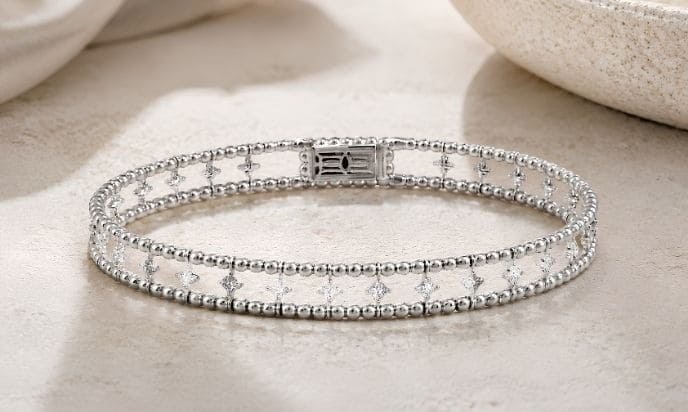 White gold two-row beaded flexible bangle with natural diamond petite flower cluster accents