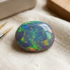 Australian Black Opal oval gemstone with colorful play of color