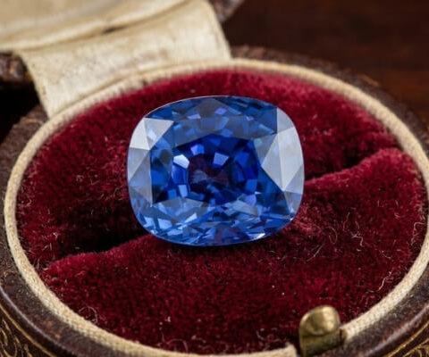 Blue Sapphire cushion cut gemstone in jewelry box