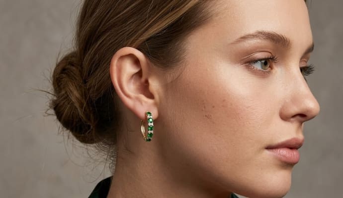Woman Wearing Green Tsavorite and Diamond Hoop Earrings