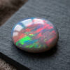 Natural Australian Black Opal oval cabochon with vibrant play of color