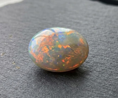 Natural Australian Crystal Opal oval cabochon with orange and blue color flashes