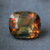 Natural bi-color sapphire cushion cut gemstone with green and orange tones
