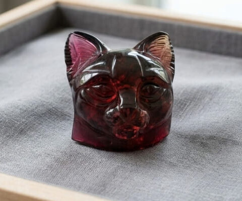 Natural bi-color tourmaline carved cat gemstone with deep red and pink tones
