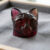 Natural bi-color tourmaline carved cat gemstone with deep red and pink tones
