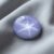 Natural blue gray star sapphire gemstone on soft grey fabric