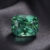 Natural blue green sapphire gemstone on dark grey fabric