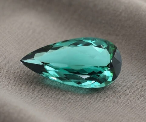 Natural blue green tourmaline gemstone with pear cut brilliance