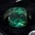 Natural oval blue green tourmaline gemstone on black jewelry display