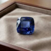 Natural blue sapphire gemstone with GIA report displayed on luxurious velvet jewellery box