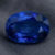 Natural blue sapphire gemstone with GIA report showing oval cut and vivid blue brilliance