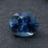 Natural blue sapphire gemstone with oval cut showing deep blue color and brilliant facets