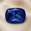 Natural blue sapphire gemstone on soft beige fabric