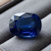 Natural blue sapphire gemstone on grey jewelry display
