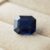 Natural blue sapphire with GIA report on cream jewelry display