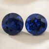 Natural round blue sapphire matching pair on soft cream fabric