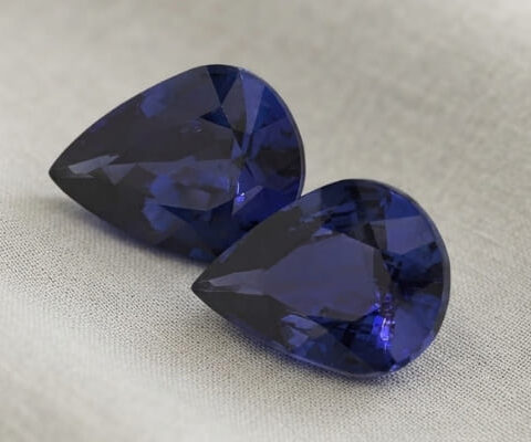Natural blue sapphire matching pair on soft beige fabric