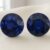 Natural round blue sapphire gemstone pair on soft cream fabric