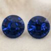 Natural round blue sapphire matching pair on soft beige fabric