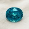 Natural round blue zircon gemstone on soft cream fabric