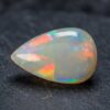 Natural Brazilian opal gemstone on dark stone surface