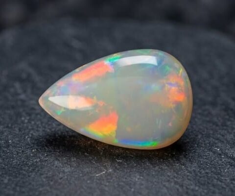 Natural Brazilian opal gemstone on dark stone surface