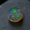 Natural Brazilian opal gemstone on dark stone jewelry display