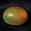 Natural Brazilian opal gemstone on black velvet fabric