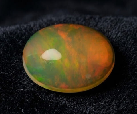 Natural Brazilian opal gemstone on black velvet fabric