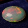 Natural Brazilian opal gemstone on deep blue velvet display