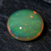Natural Brazilian opal gemstone on dark stone surface