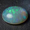 Natural Brazilian opal gemstone on dark stone surface